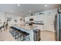 Bright eat-in kitchen featuring a granite-topped island with seating, and stainless appliances at 3353 W Shanley Ave, Apache Junction, AZ 85120