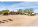 Exterior view of the property featuring a three-car garage, desert landscaping, and large lot at 38408 N 23Rd Dr, Phoenix, AZ 85086