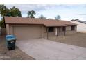 Charming single-Gathering home with a two-car garage and a spacious concrete driveway at 4110 W Cholla St, Phoenix, AZ 85029