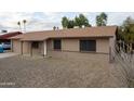 Inviting ranch-style home with a charming brick facade and well-maintained gravel yard at 4110 W Cholla St, Phoenix, AZ 85029