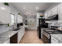 Contemporary kitchen with granite counters, stainless steel appliances, and white cabinets providing ample storage at 6461 S Kimberlee Way, Chandler, AZ 85249