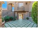 Beautiful courtyard featuring an outdoor staircase, stone archway, and decorative stone and turf flooring at 9290 E Thompson Peak Pkwy # 470, Scottsdale, AZ 85255