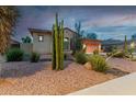 Charming single-story home with xeriscaping, desert plants, and a cozy aesthetic at 9295 W Quail Track Dr, Peoria, AZ 85383