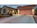 Spacious home with a three-car garage and a well-lit driveway at 9295 W Quail Track Dr, Peoria, AZ 85383