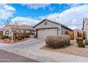 Attractive one-story home boasting desert landscaping and a spacious driveway leading to a garage at 9520 W Trumbull Rd, Tolleson, AZ 85353