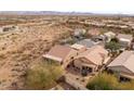 Scenic aerial view of a desert home with a private backyard patio and surrounding community at 10188 E Rugged Mountain Dr, Gold Canyon, AZ 85118