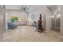 Spacious living room featuring tile flooring, high ceilings and a ceiling fan at 10881 W Melinda Ln, Sun City, AZ 85373