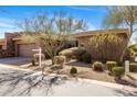 A well-maintained single-Gathering home featuring desert landscaping, a two-car garage, and a neutral stucco exterior at 10883 E La Junta Rd, Scottsdale, AZ 85255