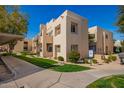 Beige complex featuring desert landscaping, sidewalks and building with reserved parking and green landscaping at 11333 N 92Nd St # 2028, Scottsdale, AZ 85260