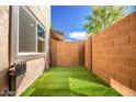 Backyard features artificial turf and block fencing offering privacy at 1214 N 84Th Pl, Scottsdale, AZ 85257