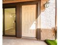 Inviting front entrance featuring a secure door and stylish exterior lighting fixture at 1214 N 84Th Pl, Scottsdale, AZ 85257