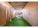 Outdoor patio space, includes a table with four chairs, astroturf and shade covering at 1214 N 84Th Pl, Scottsdale, AZ 85257