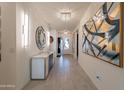 Elegant foyer featuring recessed lighting, a modern console table and decorative artwork at 13568 N 144Th Dr, Surprise, AZ 85379