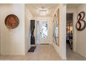 Bright foyer with modern lighting fixtures and stylish decorative art pieces at 13568 N 144Th Dr, Surprise, AZ 85379