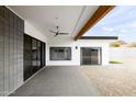 Modern back patio with block wall, ceiling fan and access to the yard at 14025 N 11Th Pl, Phoenix, AZ 85022