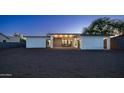 Large backyard with gravel landscaping, fenced perimeter, and a covered patio at 14025 N 11Th Pl, Phoenix, AZ 85022