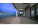 Covered patio area featuring a ceiling fan and sliding glass doors that open up to the interior at 14025 N 11Th Pl, Phoenix, AZ 85022