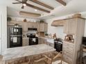 Bright kitchen features a large island, light wood cabinets, and stainless steel appliances at 1455 W Posada Ave, Mesa, AZ 85202