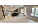 Spacious kitchen featuring an island, stainless steel appliances, modern lighting, and views of backyard at 1544 N Rico Cir, Mesa, AZ 85213