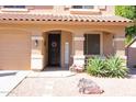 Inviting front entrance with decorative wreath, ample lighting, tasteful landscaping and a three car garage at 16626 W Baden Ave, Goodyear, AZ 85338