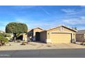 Inviting single-story home showcases desert landscaping, mature trees, and an attached two-car garage at 2101 S Meridian Rd # 354, Apache Junction, AZ 85120