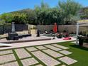 Spacious backyard offering a pool, patio, lounge areas, and lawn, ideal for recreation and relaxation at 2260 E Palmaire Ave, Phoenix, AZ 85020