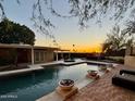 Sunset view of the private pool and backyard oasis featuring multiple lounge areas and desert landscaping at 2260 E Palmaire Ave, Phoenix, AZ 85020