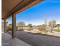 A lovely back patio features paver flooring and desert landscaping with unobstructed views of the golf course at 26880 W Sierra Pinta Dr, Buckeye, AZ 85396