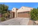 Front exterior showcasing a two-car garage and landscaped front yard at 26880 W Sierra Pinta Dr, Buckeye, AZ 85396