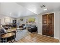 Spacious living room featuring wood floors, large windows, and comfortable seating areas for relaxation and entertaining at 401 E Marconi Ave, Phoenix, AZ 85022
