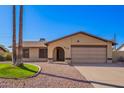Charming single-story home featuring desert landscaping, a two-car garage and neutral toned exterior paint at 5123 E Beck Ln, Scottsdale, AZ 85254