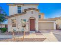 Home exterior with arched entryway, desert landscaping, and two car garage at 5145 W Odeum Ln, Phoenix, AZ 85043