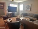 Cozy living area with a large television, comfortable seating, and warm lighting at 6943 W Devonshire Ave # 1355, Phoenix, AZ 85033