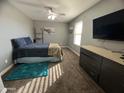 Comfortable main bedroom with a ceiling fan, dresser, and a view from the window at 6943 W Devonshire Ave # 1355, Phoenix, AZ 85033