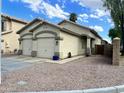 Charming home featuring a two-car garage, desert landscaping and inviting curb appeal at 723 E Whitten St, Chandler, AZ 85225