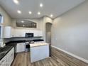 Well-lit kitchen featuring a butcher block island, sleek countertops, and ample cabinet space at 723 E Whitten St, Chandler, AZ 85225