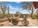 Inviting outdoor courtyard with a fountain, fire pit, and comfortable seating, perfect for relaxing at 8540 E Mcdowell Rd # 125, Mesa, AZ 85207