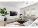 Bright living room featuring stylish gray sectional sofa, round coffee table, and elegant decor at 9013 S 15Th Way, Phoenix, AZ 85042