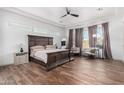 Spacious main bedroom with hardwood floors, recessed lighting, and large windows with decorative curtains at 9013 S 15Th Way, Phoenix, AZ 85042
