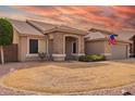 Charming single-story home with a desert landscape, neutral paint, and an arched stone porch at 9751 E Impala Ave, Mesa, AZ 85209