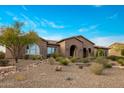 Elegant single-story home featuring desert landscaping and a welcoming brick facade at 10902 N 138Th Pl, Scottsdale, AZ 85259