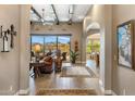 Open-concept living room with beamed ceilings, large windows, and elegant decor at 10902 N 138Th Pl, Scottsdale, AZ 85259