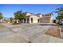 Spacious home exterior featuring large driveway and well-maintained landscaping at 11933 N 140Th Ln, Surprise, AZ 85379