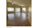 Spacious living room featuring tiled floors, lots of windows for natural light and high ceilings at 14930 N Gil Balcome Ct, Surprise, AZ 85379