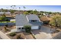 An aerial view shows the home with well-maintained landscaping, a 2-car garage and mature trees at 1655 W Meseto Cir, Mesa, AZ 85202