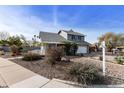 Charming two-story home with manicured landscaping, gray exterior, and a welcoming covered porch at 1655 W Meseto Cir, Mesa, AZ 85202