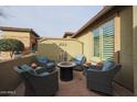 Cozy outdoor patio area with comfortable seating and a fire pit, perfect for entertaining at 17662 W Cedarwood Ln, Goodyear, AZ 85338