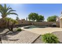 Backyard pool oasis with lush landscaping, a patio area, and a built-in grill for outdoor entertaining and Gathering fun at 41201 N Stenson Dr, San Tan Valley, AZ 85140