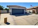 Exterior view of the home with a driveway, two-car garage, and low maintenance landscaping at 5255 W Cochise Dr, Glendale, AZ 85302