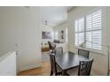 Inviting dining area with open floor plan views of the living room, hardwood floors, and modern lighting fixtures at 615 E Portland St # 160, Phoenix, AZ 85004